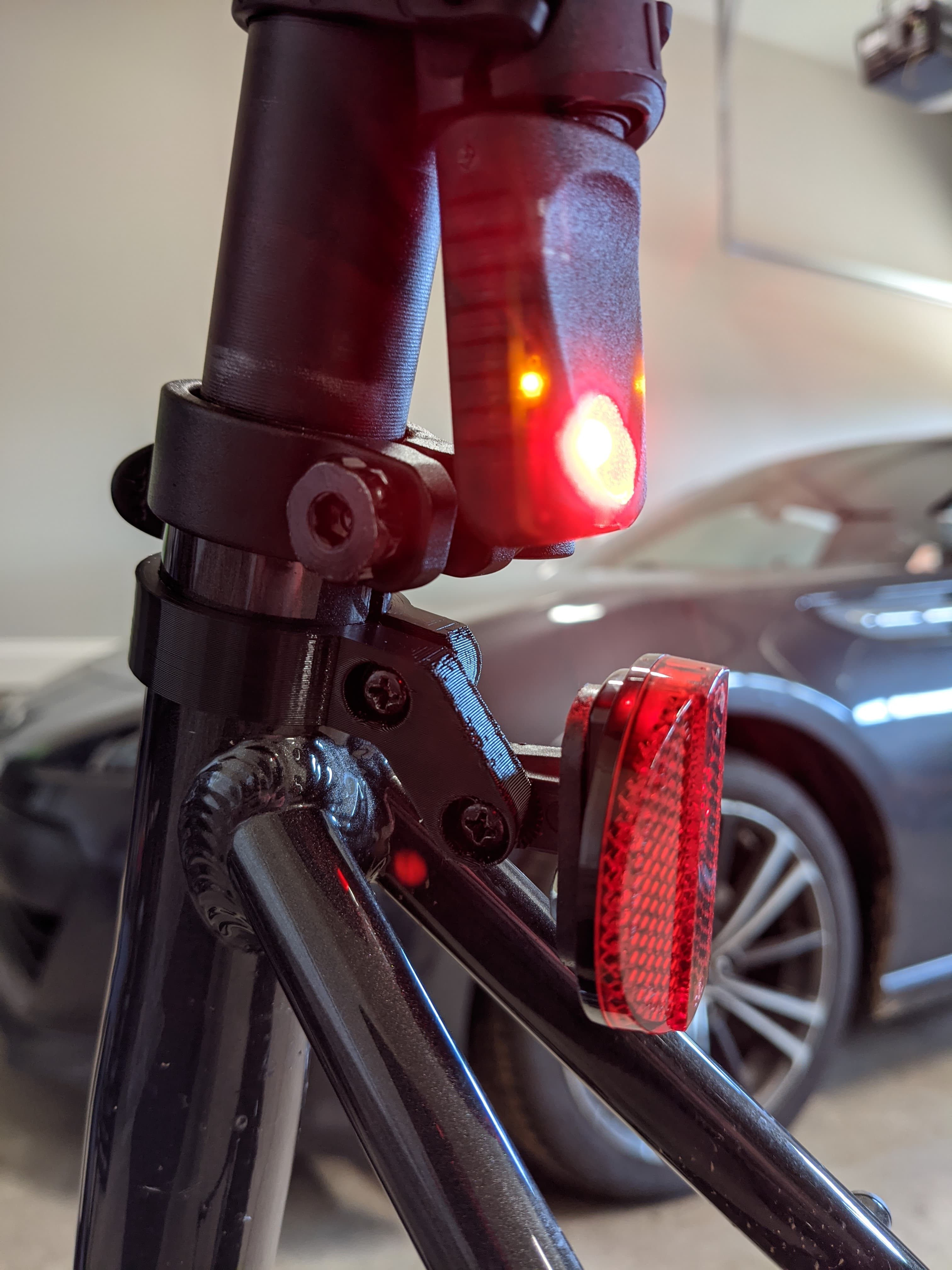 A 3d-printed adapter for mounting a rear reflector on a bicycle, designed, sliced, and printed from a Chromebook